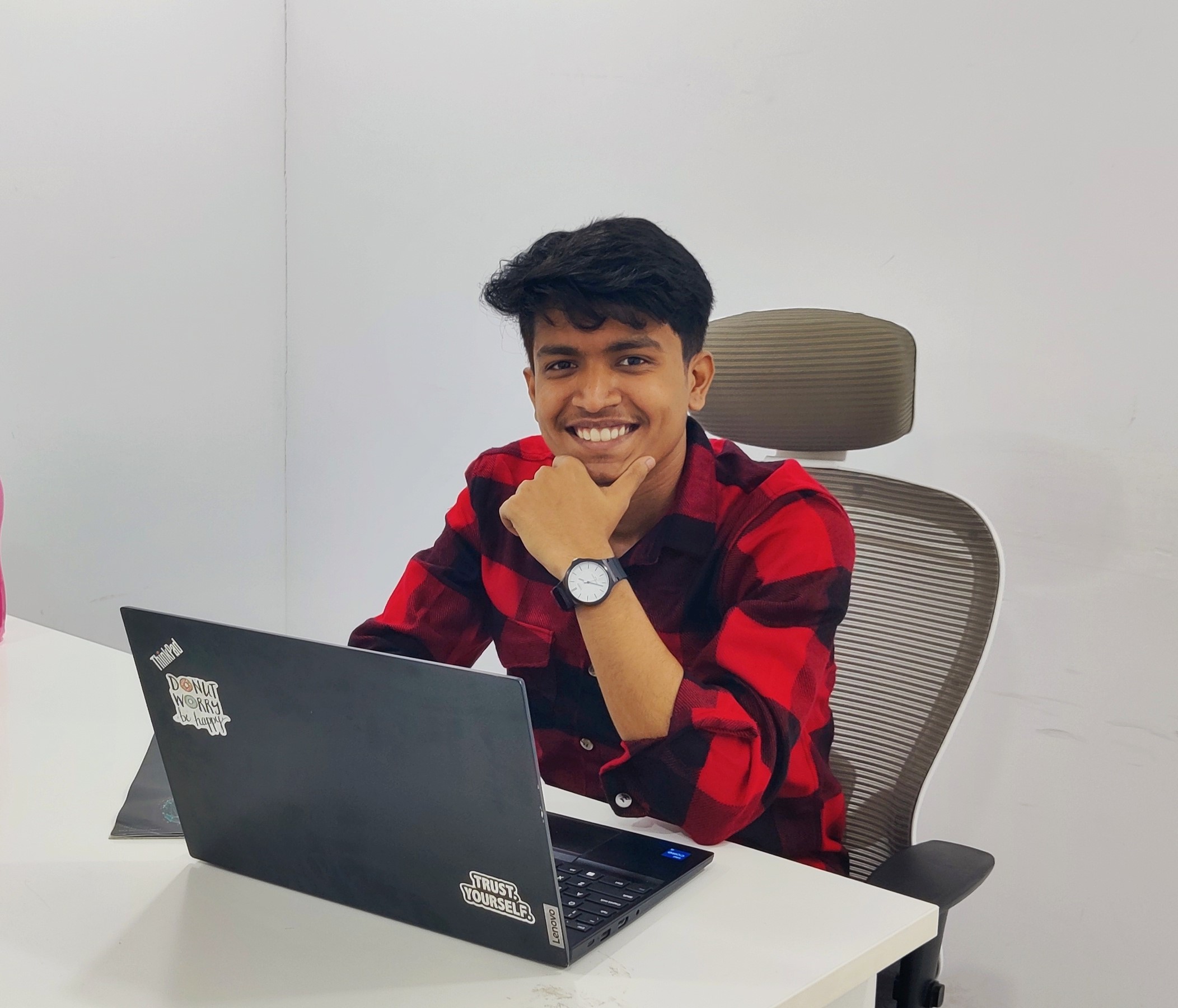 Prathamesh Kasar smiling at a desk with a laptop