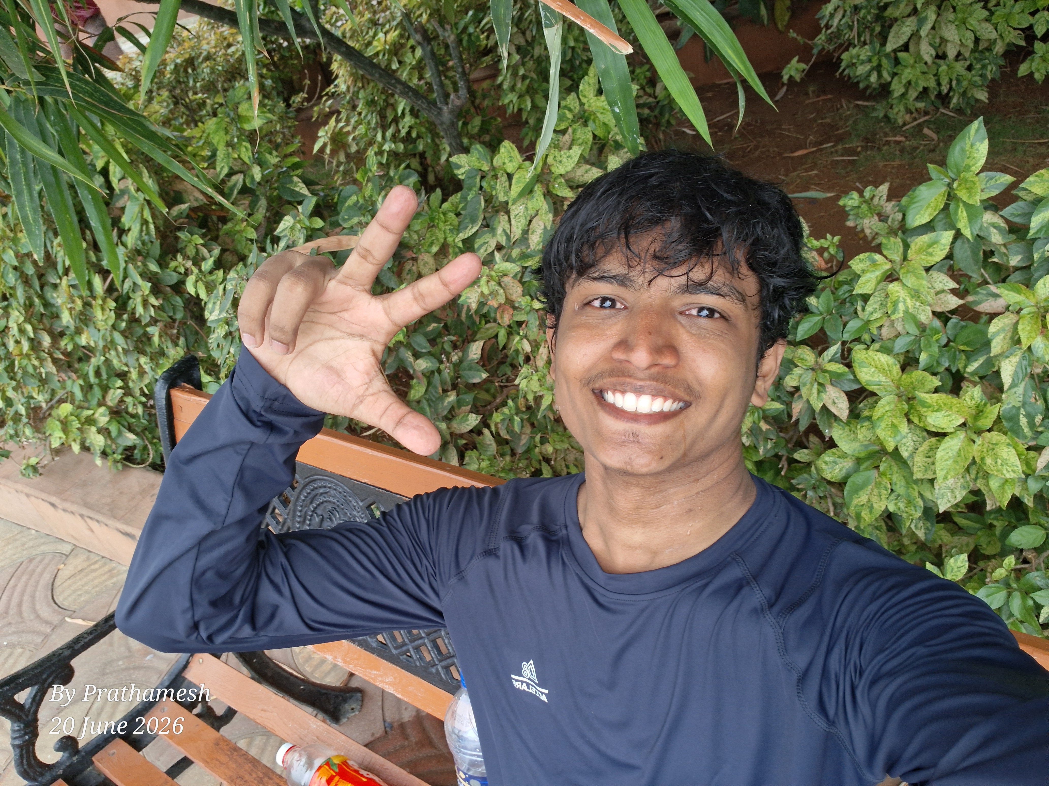 Prathamesh Kasar smiling outdoors among green plants