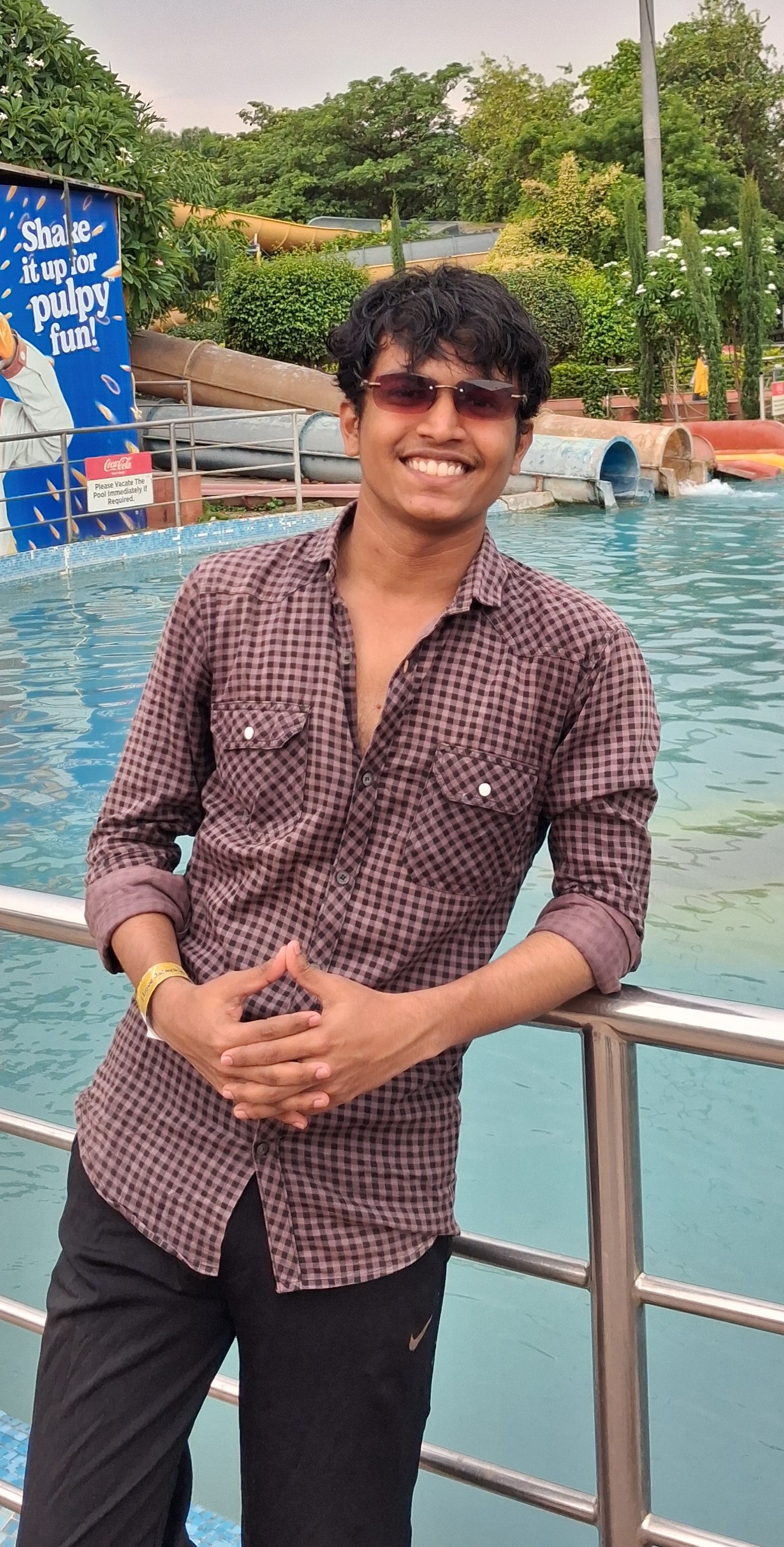 Prathamesh Kasar in sunglasses by a pool