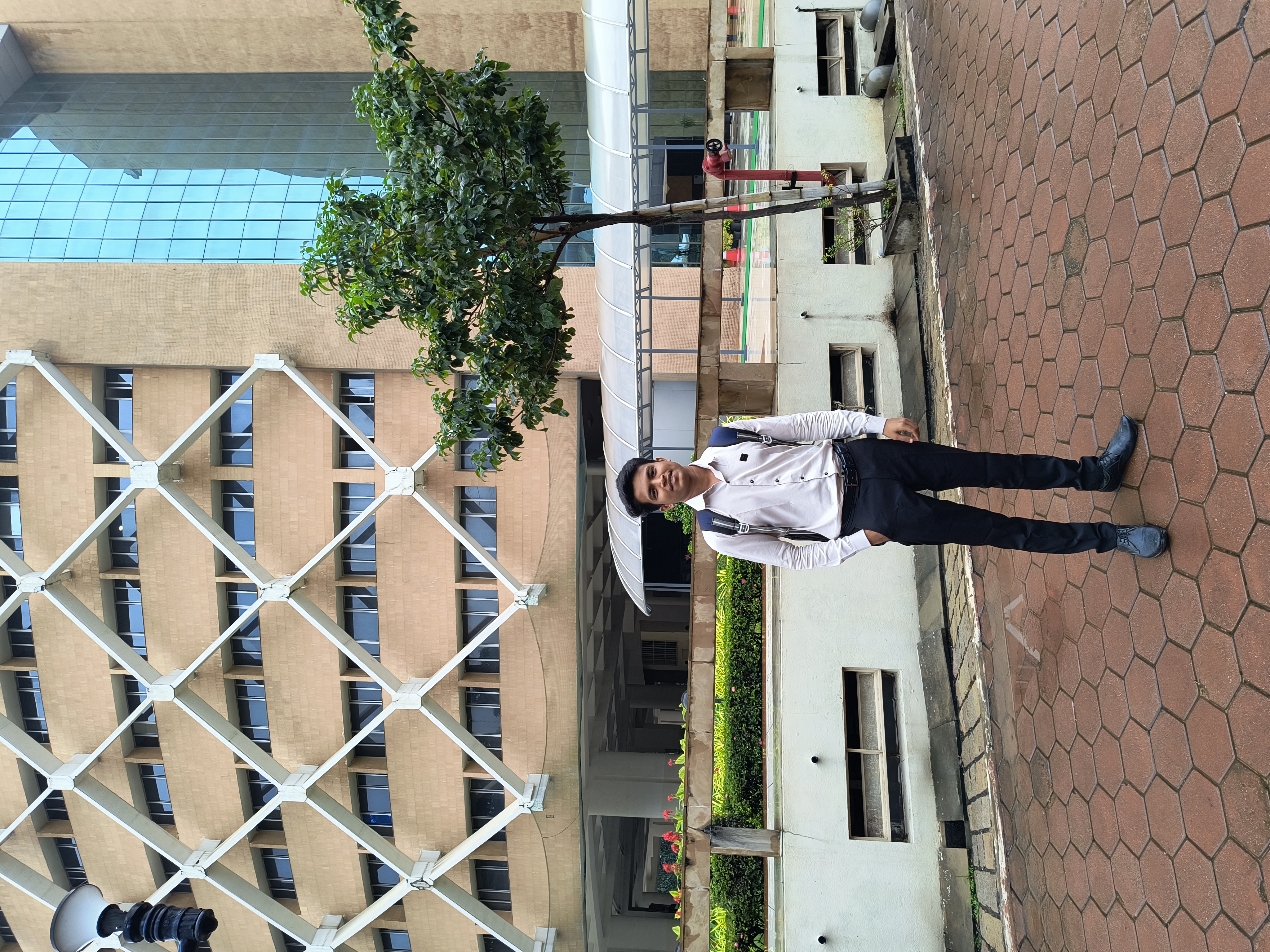 Prathamesh Kasar in formal wear outside an office campus