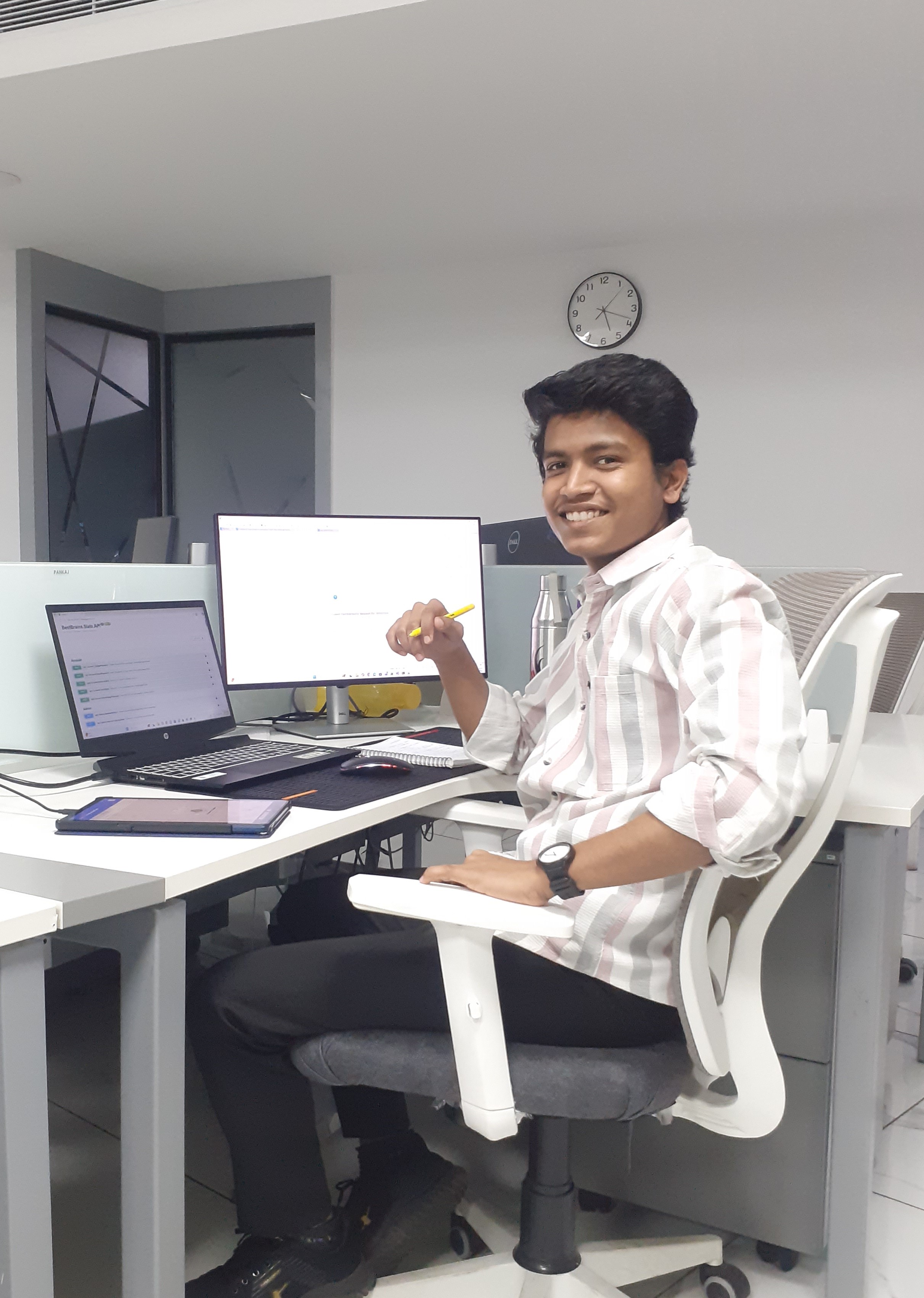 Prathamesh Kasar, software engineer, working at a desk with a laptop and monitor