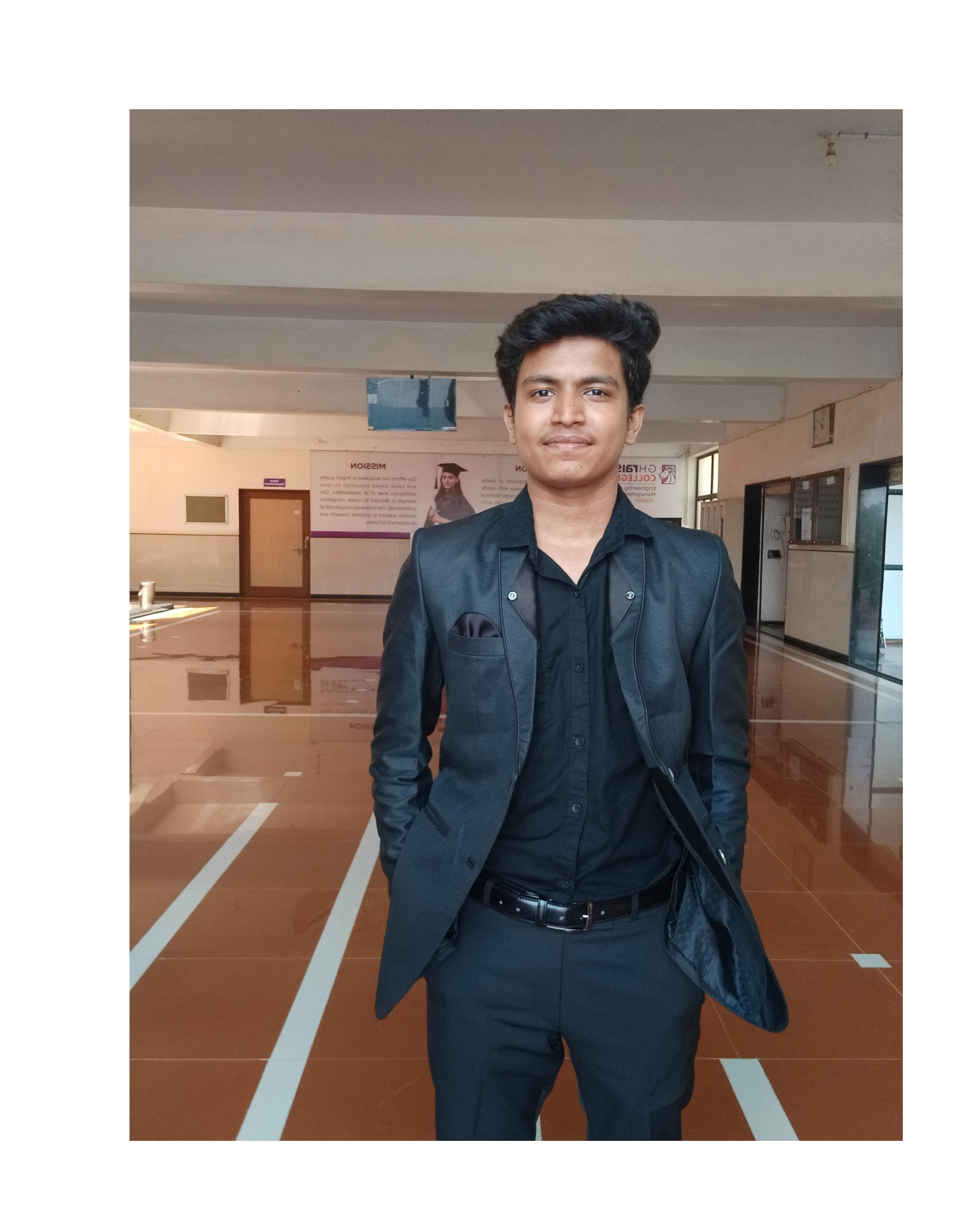 Prathamesh Kasar in a black jacket, standing in an office lobby
