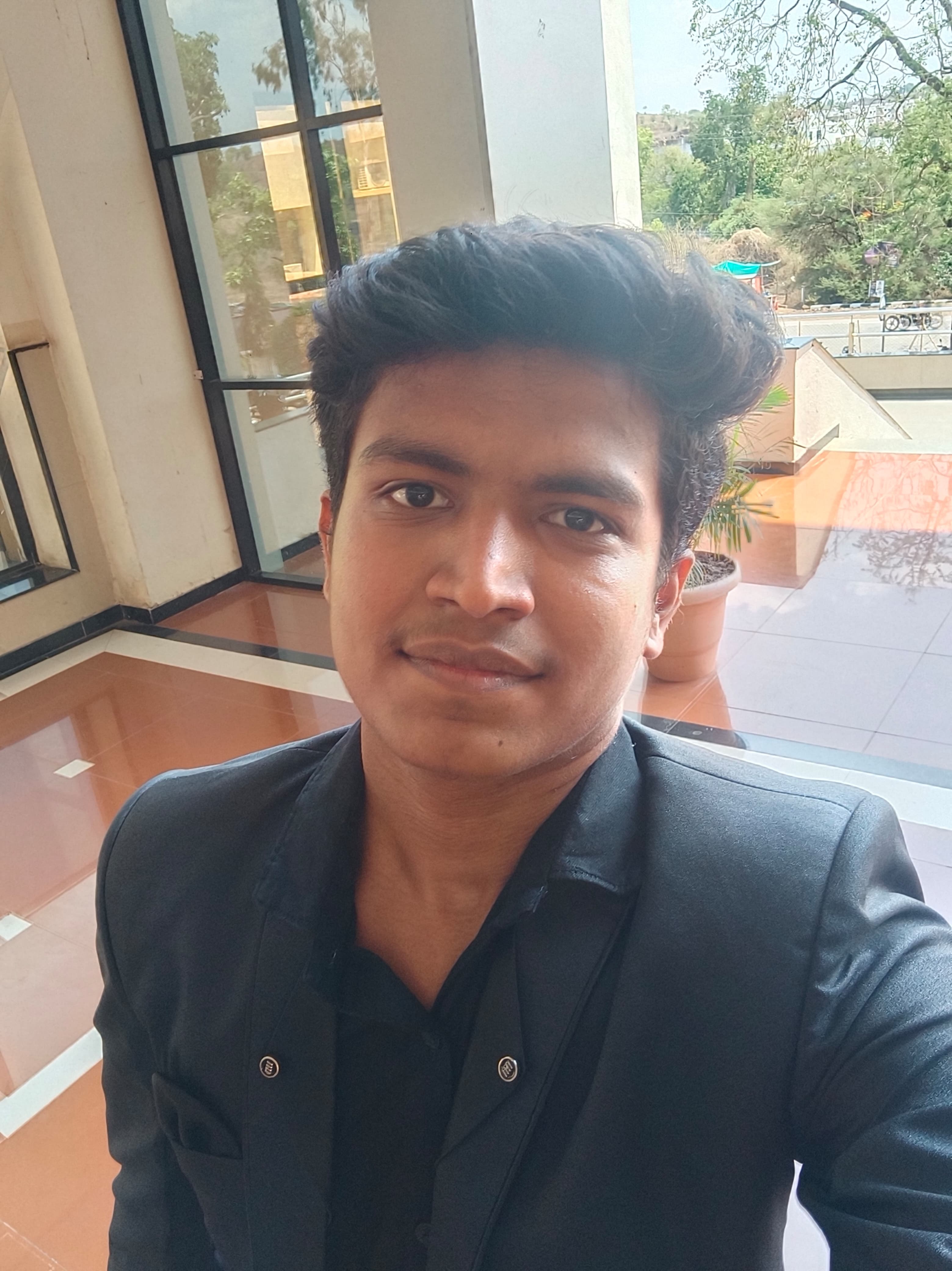 Prathamesh Kasar, close-up portrait in a dark blazer